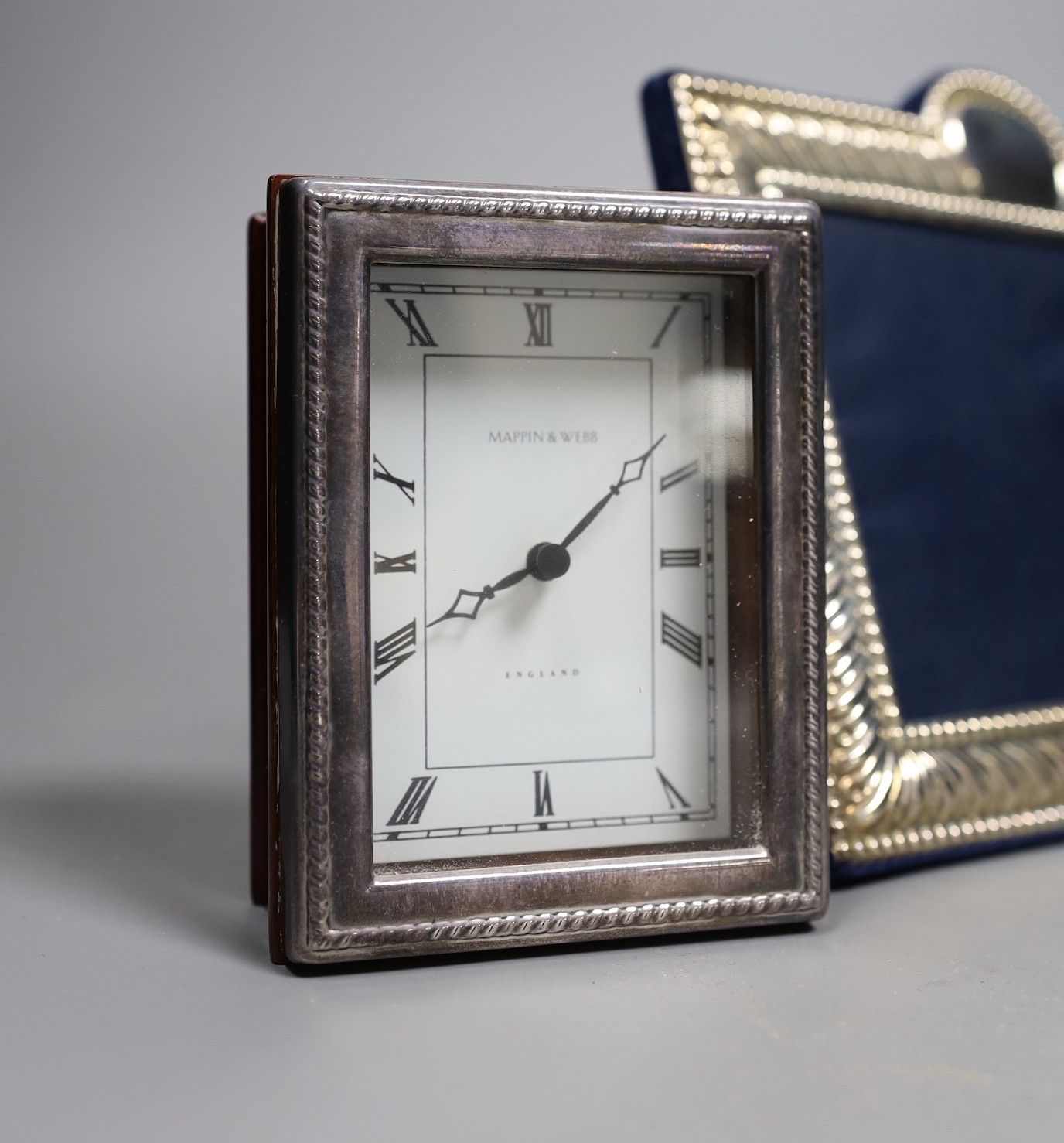 Two modern silver mounted photograph frames and a similar silver mounted Mappin & Webb timepiece, 10.6cm.